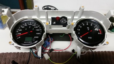 GPS speedometer with custom logos for the lights and turn signals, 9K tachometer with custom designs. Both fit perfectly after alot of modification to the housings